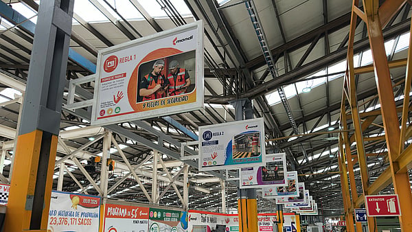 Marketing billboard display suspended from the ceiling inside a Mondi warehouse.